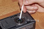 Careful removing of tiny dirt particles from a camera object lense