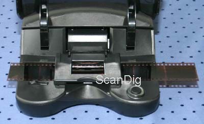 The inserted negative strip can jut out arbitrarily far to the left and the right side of the scanner.