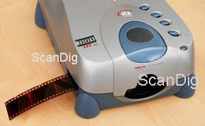 Film strips are being inserted in the scanner from the left front side